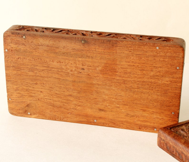 Wood Dresser Box Hand Carved Mahogany Box Lined Vintage 1960s.
Rich Hand-Carved Mahogany Dresser Box Featuring Brass Handles and Green Fabric Lining. 
The Lining is Very Old and Thin.
Wood Box Measures 6 7/8 Inches By 4 Inches By 1 1/2 Inches Tall.