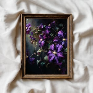 May include: A framed floral print featuring vibrant purple clematis flowers with yellow centers and green leaves against a dark background. The artwork is displayed in a brown wooden frame, creating a classic aesthetic.