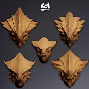 May include: Five tan-coloured dragon head sculptures with sharp teeth and textured surfaces. The heads vary in size and shape, some with elaborate, layered designs. The "koi" logo is visible in the top right corner.