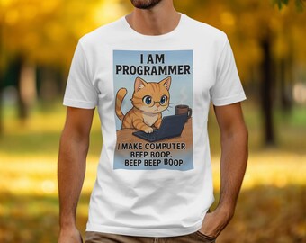 May include: White t-shirt with a cartoon cat wearing glasses, working on a laptop. Text reads "I AM PROGRAMMER" and "I MAKE COMPUTER BEEP BOOP, BEEP BEEP BOOP". The design includes a mug. A fun, geeky design.