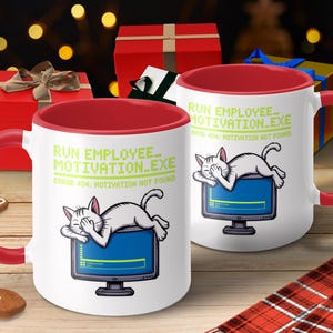 May include: White ceramic mugs with red handles and interiors. The mugs feature a cartoon cat sleeping on a computer monitor with the text "RUN EMPLOYEE_MOTIVATION.EXE ERROR 404: MOTIVATION NOT FOUND". Festive holiday theme.