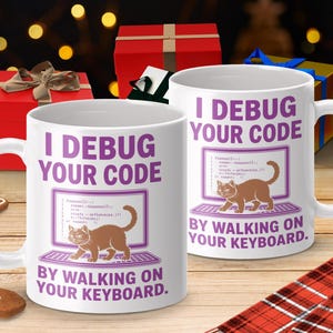 Könnte beinhalten: Weiße Keramik-Tasse mit dem Text "I DEBUG YOUR CODE" in Lila und einer Grafik einer Katze auf einem Computerbildschirm. Der Satz "BY WALKING ON YOUR KEYBOARD" ist ebenfalls enthalten. Ein humorvolles Geschenk.
