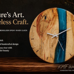 May include: A round wall clock made of light-colored boxelder wood with a central turquoise epoxy resin river. The clock features thin white hands, small dark wood hour markers, and text stating Nature's Art. Timeless Craft. 14 inch diameter.