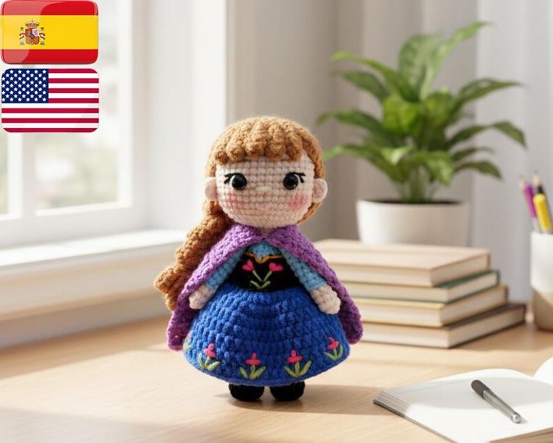May include: A crocheted doll featuring a blue dress, purple cape, and brown hair. The doll has a detailed face and is positioned on a wooden surface. The doll is a character from a popular animated film.