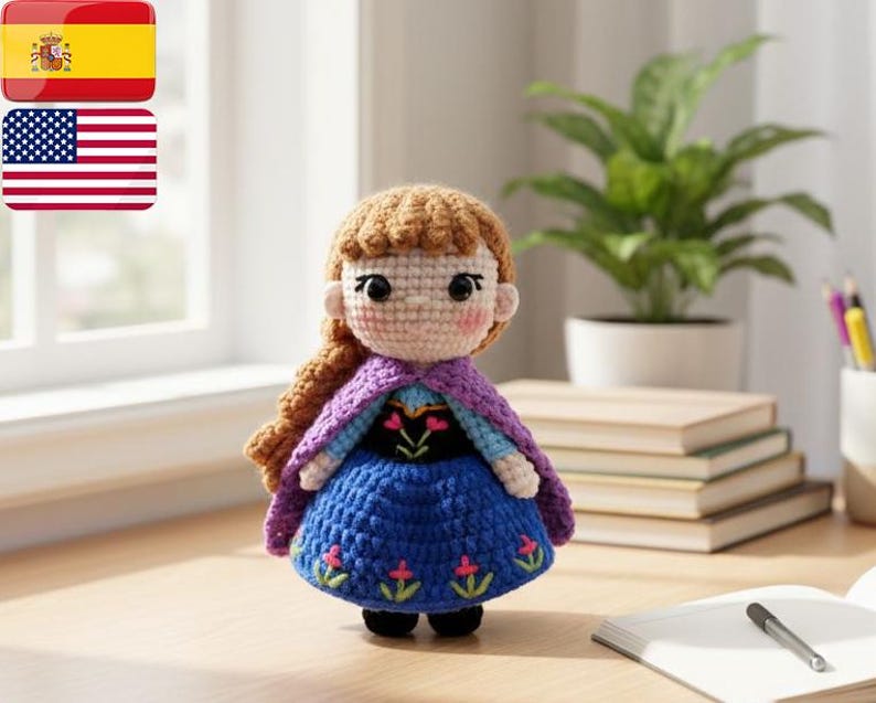 May include: A crocheted doll featuring a blue dress, purple cape, and brown hair. The doll has a detailed face and is positioned on a wooden surface. The doll is a character from a popular animated film.