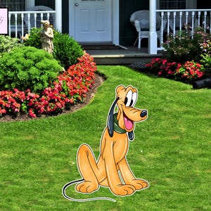 May include: A cartoon cutout of Pluto, the Disney dog, sitting on green grass. Pluto is orange with black ears, a green collar, and a pink tongue. The background includes a house, flowers, and bushes.