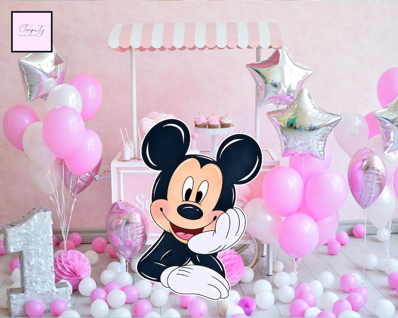 May include: A pink and white party scene with a Mickey Mouse cutout, balloons, and a small cart. The balloons are pink, white, and silver star-shaped. The cart has a pink and white striped awning. The number "1" is visible.