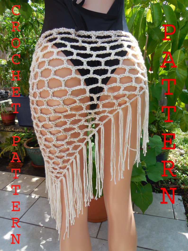 May include: A beige crochet skirt with a geometric pattern and fringe detail. The skirt is handmade and has the word "PATTERN" in red text on the right side and "CROCHET PATTERN" in red text on the left side.