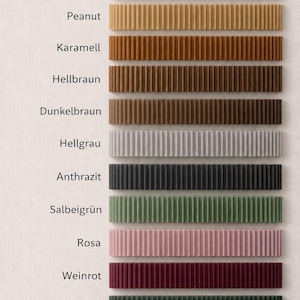 May include: A color chart displaying eleven horizontal rectangular bars with a vertical ribbed texture. The colors include white, bone, peanut, caramel, light brown, dark brown, light gray, anthracite, sage green, pink, burgundy, and dark green.