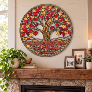 May include: A circular metal wall art piece featuring a tree with red and yellow leaves. The design includes the text 40TH ANNIVERSARY, the names Tom & Melanie, and the date 10.02.1976. The metal has a weathered, rustic finish with intricate branches.
