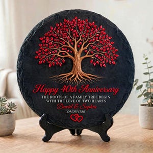 May include: A circular black slate plaque featuring a raised relief of a tree with a brown trunk and vibrant red leaves. The text reads Happy 40th Anniversary, The roots of a family tree begin with the love of two hearts, David & Sophia, 09/09/1986.