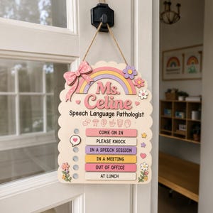 May include: A wooden door sign for a speech language pathologist named Ms. Celine, featuring a pastel rainbow, a pink bow, and floral accents. It includes a sliding indicator to select status options: Come On In, Please Knock, In A Speech Session, In A Meeting, Out Of Office, or At Lunch.