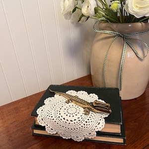 May include: A set of three ceramic vases in varying heights. The vases are white with a textured, ribbed design. The tallest vase is approximately 10 inches tall, the medium vase is 8 inches, and the smallest is 6 inches.