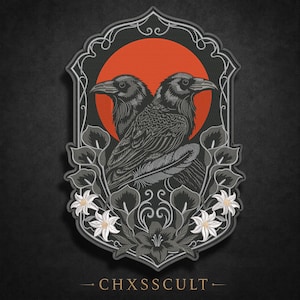 May include: A rectangular embroidered patch with a scalloped border featuring two black ravens facing opposite directions against a large orange circle. The design includes white calla lilies and foliage at the base with the text CHXSSCULT below.