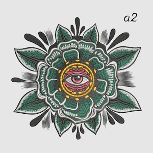 May include: Embroidered floral design featuring a central eye motif. The flower has green petals with black accents and a yellow and pink eye in the center. The text "a2" is in the upper right corner.