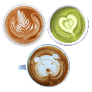 May include: Three white ceramic mugs filled with coffee and tea beverages. One mug contains a brown latte with a white fern leaf pattern, another holds a green matcha latte with a heart design, and the third features a bear face foam art.
