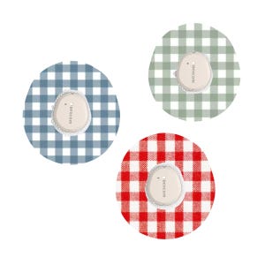 May include: Three Dexcom G6 sensor patches, each on a circular gingham background. The backgrounds are blue, green, and red. Each patch is white with the text "dexcom" printed on it.