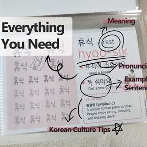 May include: A clear plastic sleeve containing a Korean language learning card. The card features the word 'hyoo-sik' with its meaning 'rest', pronunciation, example sentences, and a 'Little Story' section about the Korean jjimjilbang culture.