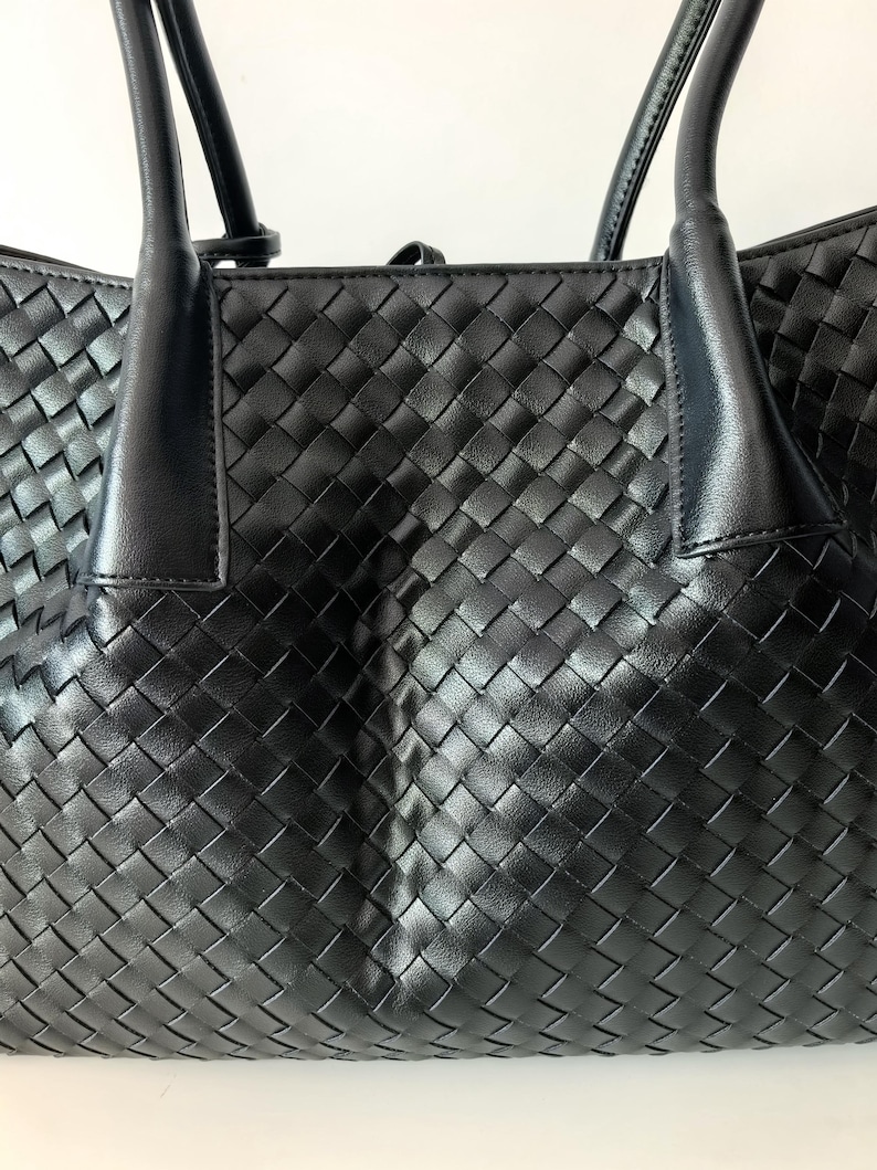 Front panel detail of black woven nappa leather tote bag with intrecciato weave