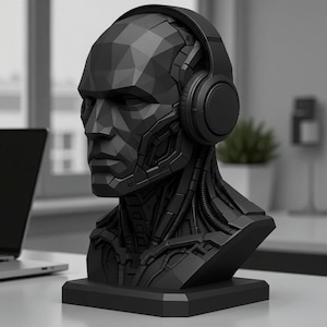May include: A matte black bust of a human head featuring a geometric, low-poly design with intricate mechanical and robotic detailing on the neck and jawline. The sculpture wears a pair of over-ear headphones and rests on a square base.