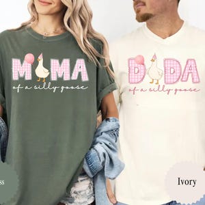 May include: Two t-shirts, one moss green and one ivory, featuring the text "MAMA of a silly goose" and "DADA of a silly goose" in pink plaid letters. Each shirt has a cartoon goose wearing a party hat and holding a pink balloon.