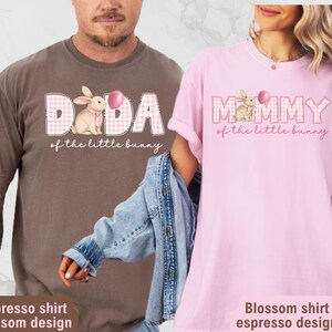 May include: Two t-shirts, one espresso and one blossom pink, feature the text "DADA" and "MOMMY" with a bunny graphic and the phrase "of the little bunny." The shirts have a relaxed fit and are perfect for Easter.