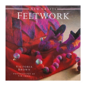 May include: A book cover titled "Feltwork" with felted crafts. The cover features a red background with felted slippers, a garland of felt balls, and a felted structure. The author is Victoria Brown, with photography by Tim Imrie.