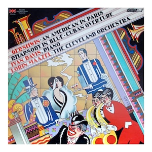 May include: Vintage album cover featuring a colorful art deco design. The cover showcases the text "Gershwin: An American in Paris, Rhapsody in Blue, Cuban Overture" with "Ivan Davis, Piano" and "The Cleveland Orchestra." The artwork includes stylized figures and musical instruments.