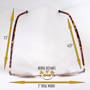 May include: Eyeglasses with a 5-inch total width, .75-inch bridge distance, and 5.5-inch and 4.25-inch temples. The frames are silver-toned with tortoise shell arms. The glasses have a classic, rectangular shape.