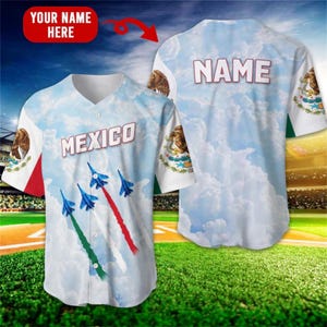 May include: A baseball jersey with a sky-blue background and white clouds. The front displays the word "MEXICO" and blue jets with red, white, and green contrails. The sleeves feature the Mexican flag and an eagle emblem. The back says "NAME".