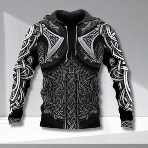 May include: Black and grey hooded sweatshirt featuring a Viking armour design. The design includes axes and intricate knotwork. The sleeves and torso are covered in the pattern, creating a bold, graphic look. The sweatshirt has a zip-up front.