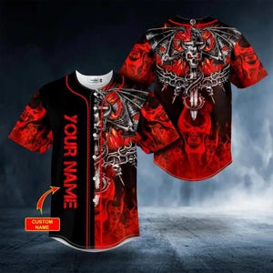 May include: Black baseball jersey with a red and white graphic design. The design features a skull with wings, a sword, and flames. The text "YOUR NAME" is printed vertically on the front. The jersey has a button-up front and short sleeves.