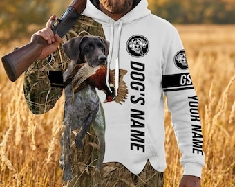 May include: White hoodie with a hunting dog and pheasant graphic. The hoodie features the text "DOG'S NAME" vertically down the side and "YOUR NAME" on the sleeve. The design incorporates a camouflage pattern.