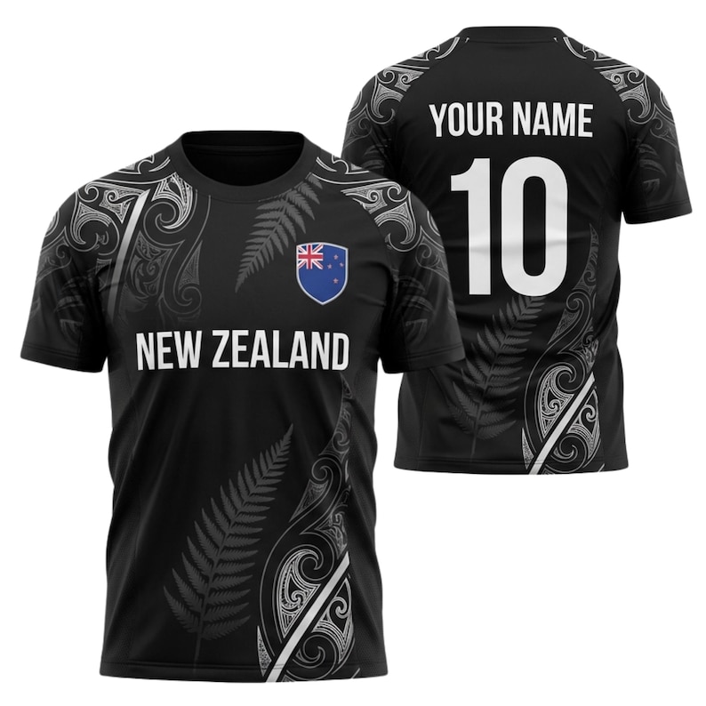 May include: Black New Zealand rugby jersey with white fern and tribal designs. The front displays "NEW ZEALAND" and a shield with the New Zealand flag. The back has "YOUR NAME" and the number "10" in white.