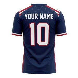 May include: Navy blue athletic jersey with white and red accents. The back features the number 10 in white with a red outline, and the text "YOUR NAME" above. A pattern of small white stars is visible.