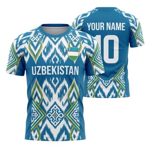 May include: A blue and white Uzbekistan soccer jersey with the word "UZBEKISTAN" across the chest. The jersey features a geometric pattern and the number "10" on the back, with space for a name.