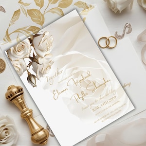 May include: Elegant wedding invitation with gold script and floral accents. The invitation features the names Eleanor Fitzgerald & Phyllis Schwaigher, with the date June 14th, 2009. Includes a gold ring set and a decorative gold stamp.