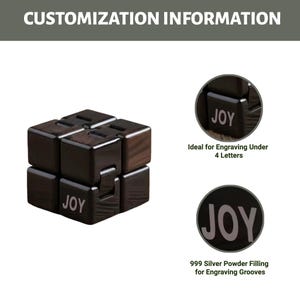Puede incluir: Un cubo de madera oscura con la palabra "JOY" impresa en un lado. El cubo est&aacute; hecho de varios bloques m&aacute;s peque&ntilde;os que se pueden mover. La imagen tambi&eacute;n muestra primeros planos del cubo con el texto "Ideal for Engraving Under 4 Letters" y "999 Silver Powder Filling for Engraving Grooves".