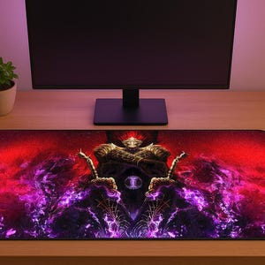 May include: A rectangular gaming mousepad featuring a fantasy warrior design. The artwork showcases a figure with a crown and swords against a backdrop of red and purple hues. The mousepad is placed on a wooden desk, with a computer monitor and a small potted plant in the background.