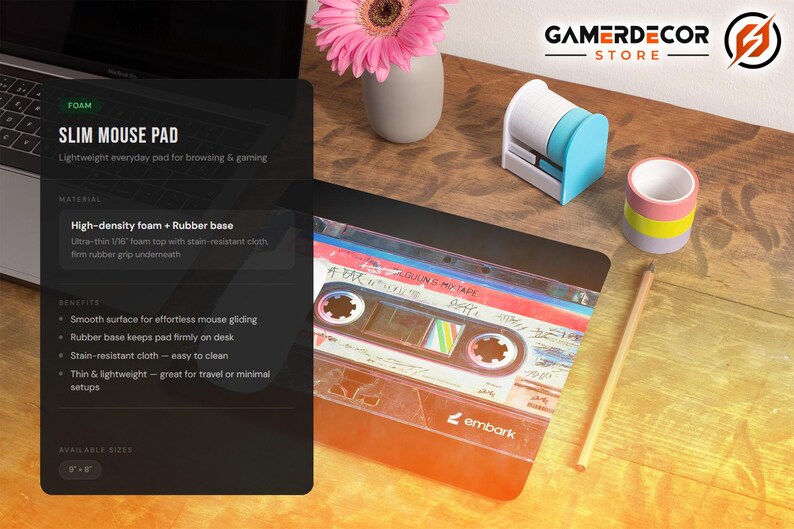 May include: A slim mouse pad with a retro cassette tape design. The pad is made of high-density foam with a rubber base, measuring 8" x 8". Other desk accessories include a pencil, tape dispenser, and a small vase with a pink flower.