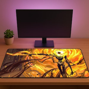 May include: A rectangular gaming mousepad featuring a fiery, abstract illustration in shades of yellow, orange, and black. The design depicts a humanoid figure with a glowing eye and flowing energy. A computer monitor and a potted plant are in the background.