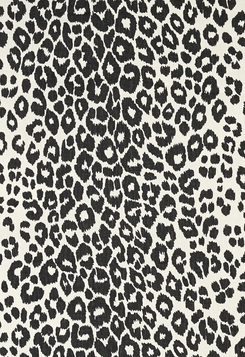 May include: Black and white leopard print fabric with a textured surface.
