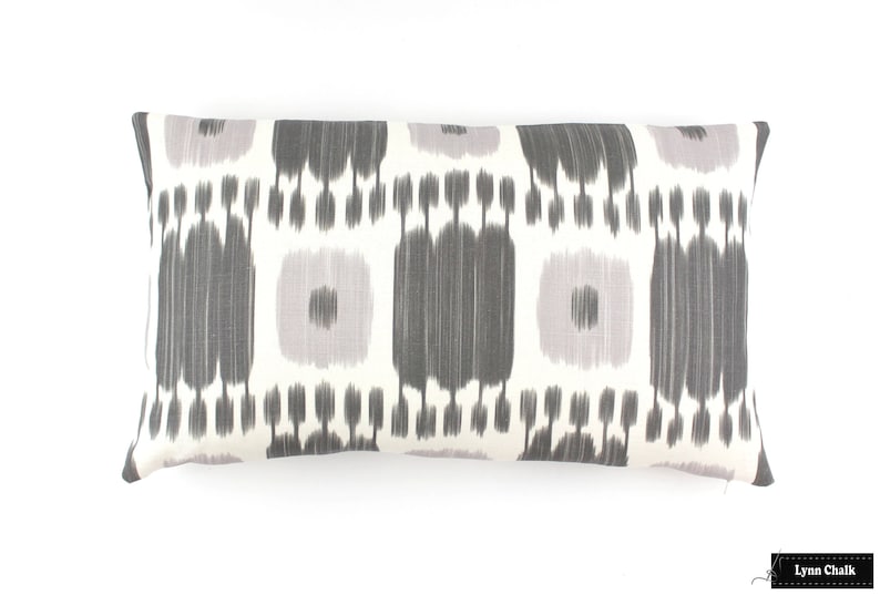 May include: A white lumbar pillow with a gray and light purple ikat pattern.