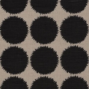 May include: A beige fabric with a repeating pattern of black, fuzzy circles.