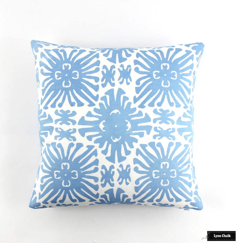 May include: A blue and white patterned throw pillow with a geometric design. The pillow is made of a soft, comfortable fabric and is perfect for adding a touch of style to any room.