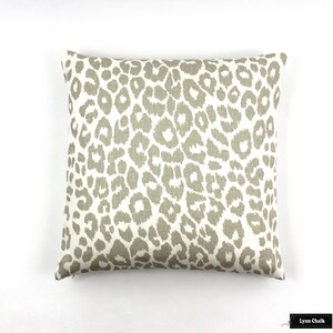 May include: A beige and white throw pillow with a leopard print pattern.