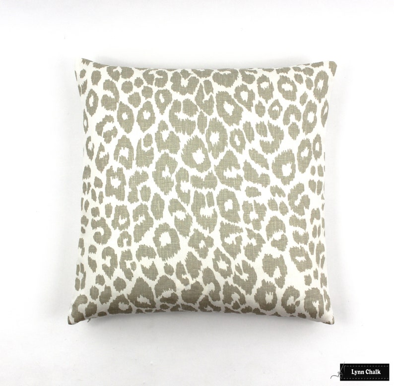 May include: A beige and white throw pillow with a leopard print pattern.