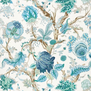 May include: A white background with a repeating pattern of blue and green floral designs. The design features stylized flowers, leaves, and branches.