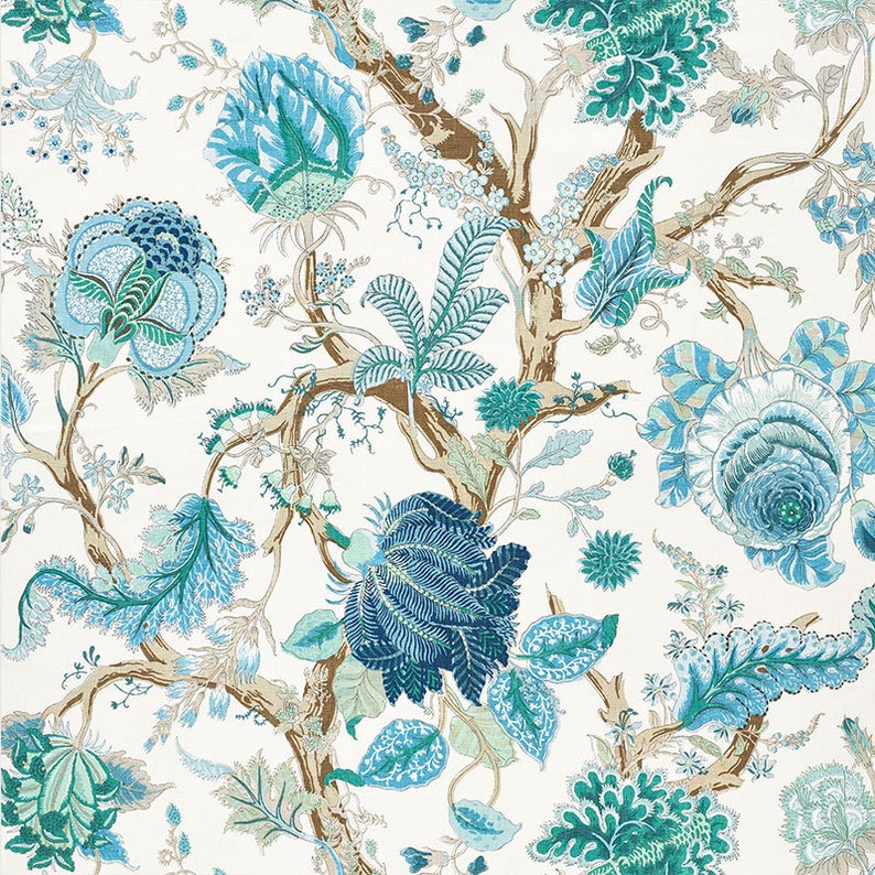 May include: A white background with a repeating pattern of blue and green floral designs. The design features stylized flowers, leaves, and branches.