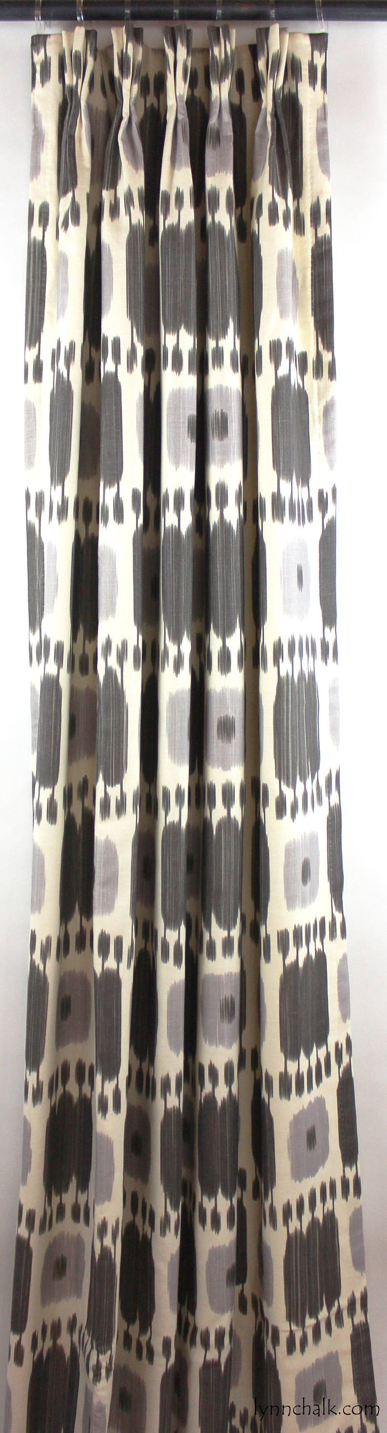 May include: Gray and white patterned curtains with a geometric design. The curtains are hung on a black curtain rod.
